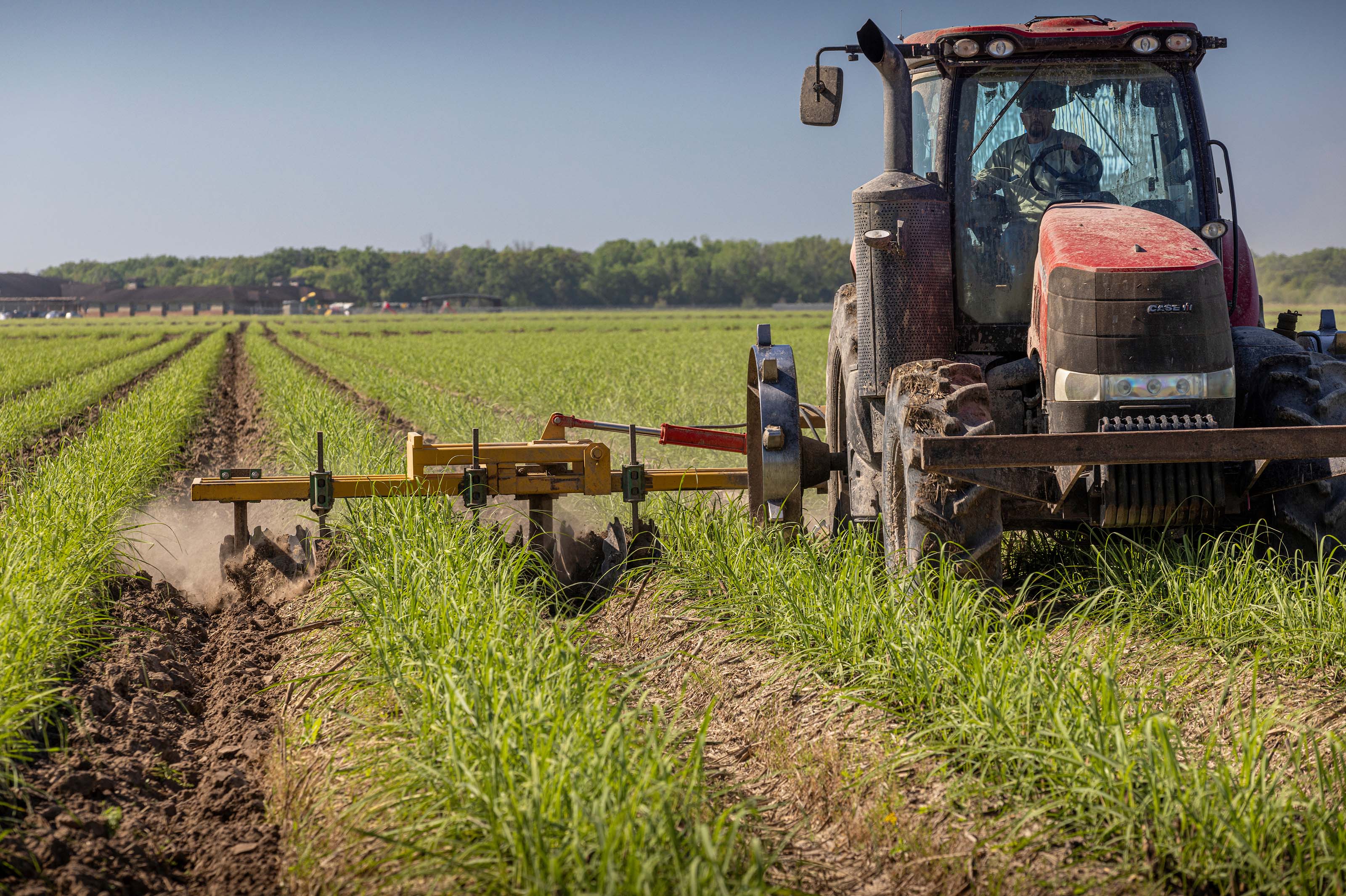a farmer driving a tractor and plowing his fields